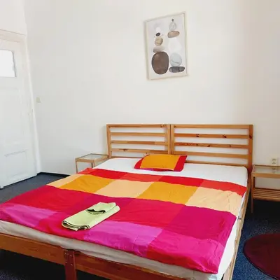a bedroom with a bed with a colorful blanket on it at Just 3 min Walk Old Town Center private room A in Prague