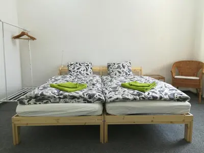 a bed with two green pillows on top of it at Just 3 min Walk Old Town Center private room A in Prague