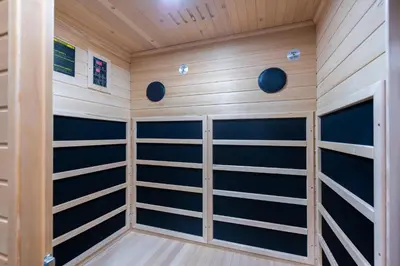 a sauna with wood paneling and blue shelves at Casa Nuova in Prague