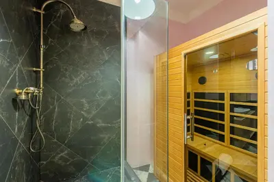 a bathroom with a shower with a glass door at Casa Nuova in Prague