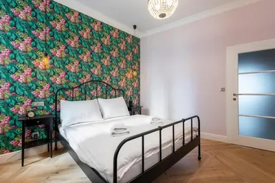 a bedroom with a bed with a floral wallpaper at Casa Nuova in Prague
