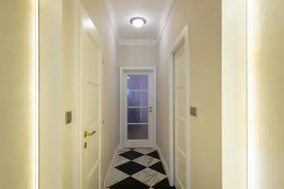 a hallway with a door and black and white checkered floor at Casa Nuova in Prague