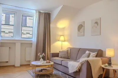 a living room with a couch and a window at Cozy Apartment in central Prague near Wenceslas Sq in Prague