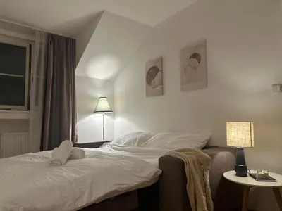 a bedroom with a bed and a table with a lamp at Cozy Apartment in central Prague near Wenceslas Sq in Prague