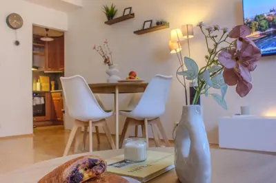 a vase with flowers on a table in a kitchen at Cozy Apartment in central Prague near Wenceslas Sq in Prague