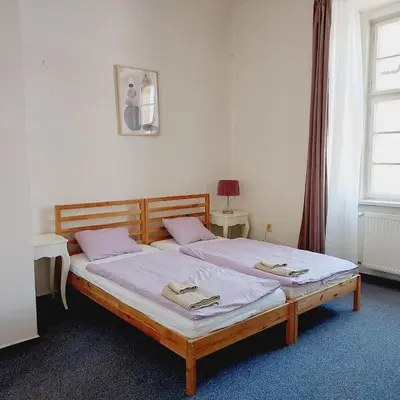 a bedroom with two beds and a window at Just 3 min Walk Old Town Center private room B in Prague