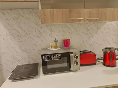 a kitchen counter with a microwave and a laptop at Just 3 min Walk Old Town Center private room B in Prague