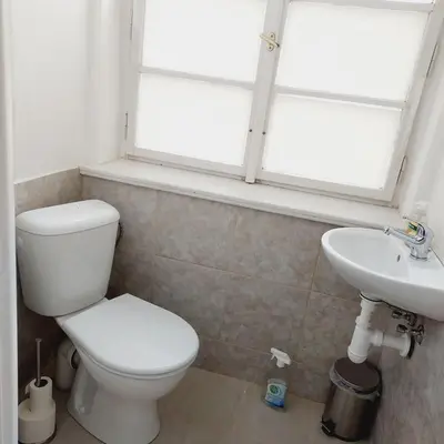 a bathroom with a toilet and a sink and a window at Just 3 min Walk Old Town Center private room C in Prague