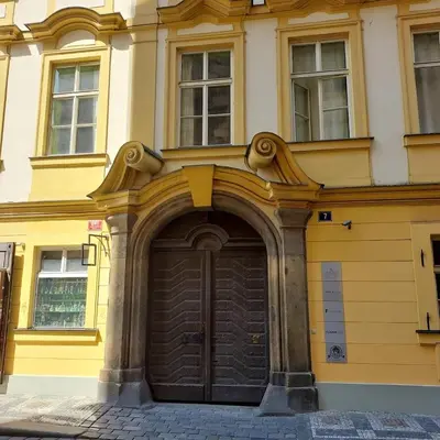 a yellow building with a large wooden door at Just 3 min Walk Old Town Center private room C in Prague