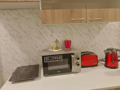 a microwave sitting on a kitchen counter with a laptop at Just 3 min Walk Old Town Center private room D in Prague