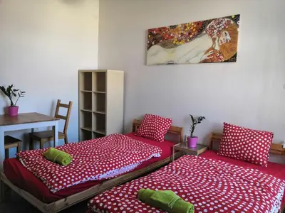 two beds in a room with a table and a painting at 3 min Walk Old Town Center private room A in Prague