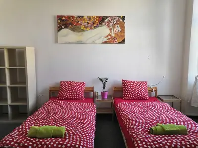 a room with two beds and a painting on the wall at 3 min Walk Old Town Center private room A in Prague