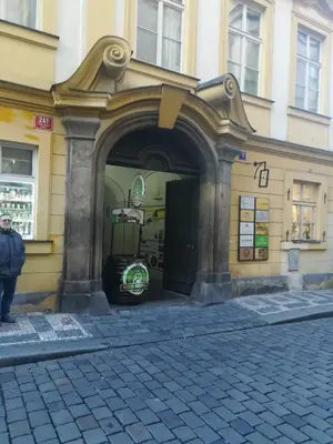 a building with an archway on the side of a street at 3 min Walk Old Town Center private room B in Prague