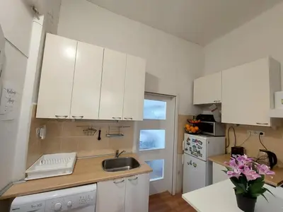 a kitchen with white cabinets and a sink at Apartment Near City Center! in Prague