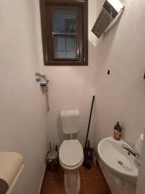 a bathroom with a toilet and a sink and a window at Apartment Near City Center! in Prague