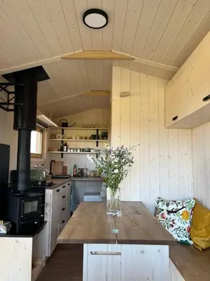 a kitchen with a table with a vase of flowers on it at Tiny u koníků