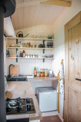 a kitchen with a stove and a counter top at Tiny u koníků