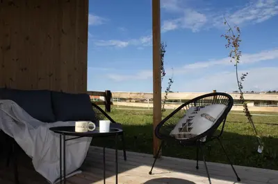 a patio with a couch and a table and a window at Tiny u koníků