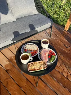 a table with a tray of food and two cups of coffee at Tiny u koníků