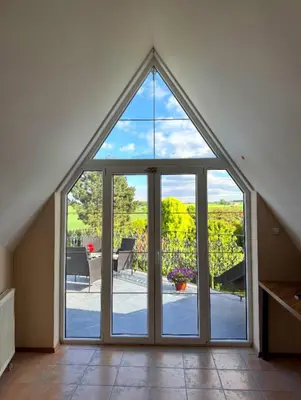 a large glass door with a view of a patio at Entire 2nd floor of Villa with 3bedroom with large garden,BBQ,pool,sauna,free parking in Popovičky