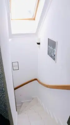 a staircase in a house with a skylight at Entire 2nd floor of Villa with 3bedroom with large garden,BBQ,pool,sauna,free parking in Popovičky