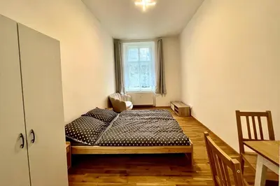 a bedroom with a bed and a window at The Hrad nest in Prague