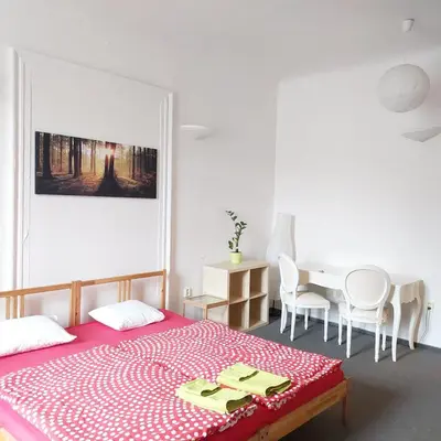 a bedroom with a bed and a table with chairs at 3 min Walk Old Town Center private room C in Prague