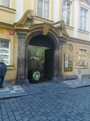 a building with an archway on the side of a street at 3 min Walk Old Town Center private room C in Prague