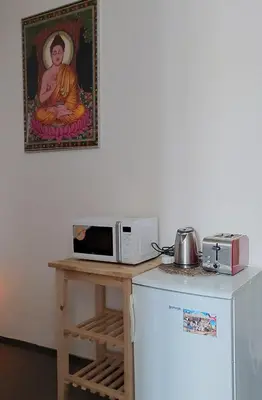 a microwave sitting on a table next to a refrigerator at 3 min Walk Old Town Center private room C in Prague