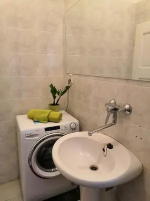 a bathroom with a washing machine and a sink at 3 min Walk Old Town Center private room C in Prague