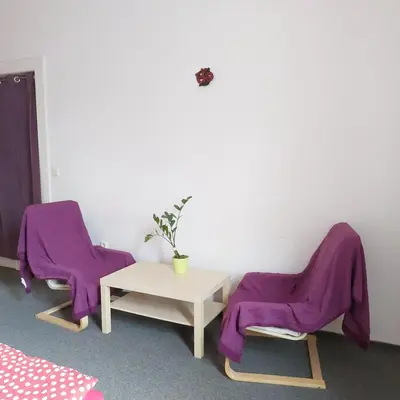 a room with two chairs and a table with purple blankets at 3 min Walk Old Town Center private room C in Prague