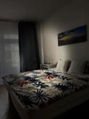 a bedroom with a bed with a colorful blanket at Kamenicka new! in Prague