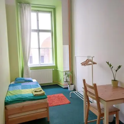 a bedroom with a bed and a table and a window at Charles bridge, Old town3 Min walk Private Room A in Prague