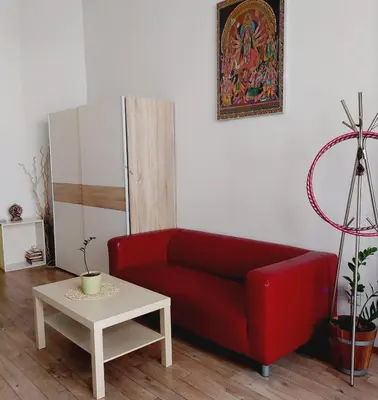 a living room with a red couch and a table at Charles bridge, Old town3 Min walk Private Room B in Prague