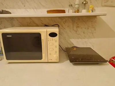 a microwave sitting on a counter next to a laptop at Charles bridge, Old town3 Min walk Private Room C in Prague