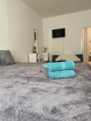 a pair of towels sitting on top of a bed at Apartment 23 in Prague