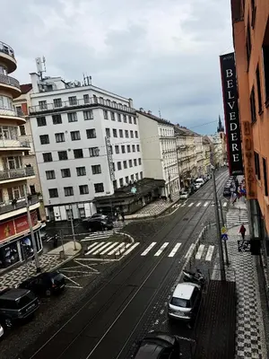 a city street with cars parked in front of buildings at Apartment 23 in Prague