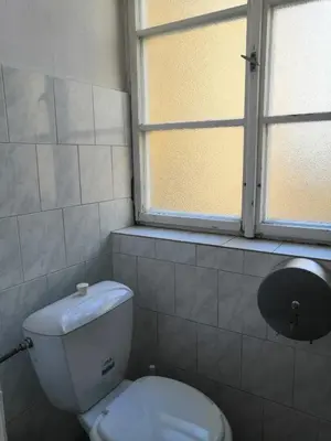 a bathroom with a white toilet and a window at Old Town Center Just in 3 min Walk private room C in Prague