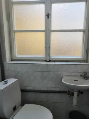 a bathroom with a toilet and a sink and a window at Old Town Center Just in 3 min Walk private room D in Prague