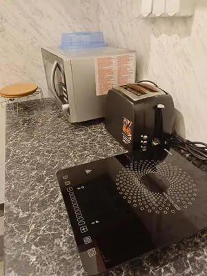 a laptop computer sitting on a counter next to a toaster at Old Town Center Just in 3 min Walk private room D in Prague