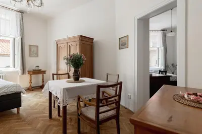 a room with a table with a vase of flowers on it at Authentically stylish apartment with a mystical view GOLEM in Prague