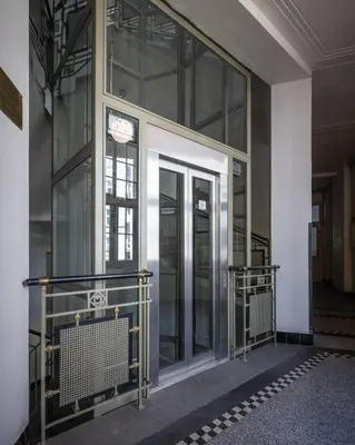 an entrance to a building with glass doors at Authentically stylish apartment with a mystical view GOLEM in Prague