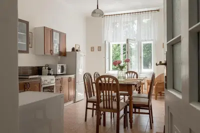 a kitchen with a dining room table and chairs at Authentically stylish apartment with a mystical view GOLEM in Prague