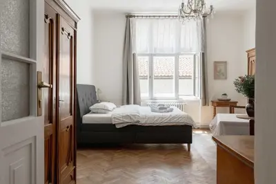 a bedroom with a bed and a window at Authentically stylish apartment with a mystical view GOLEM in Prague