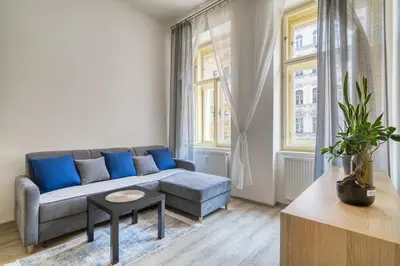 a living room with a couch and a table at Fügner's apartment by Rentez in Prague