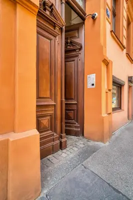 a large wooden door on the side of a building at Fügner's apartment by Rentez in Prague