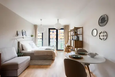 a living room with a bed and a table at Stylish and Comfortable Studio in Prague