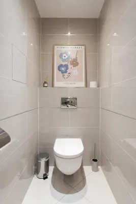 a bathroom with a toilet and a picture on the wall at Stylish and Comfortable Studio in Prague