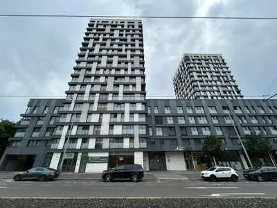 a large building with cars parked in a parking lot at Stylish and Comfortable Studio in Prague