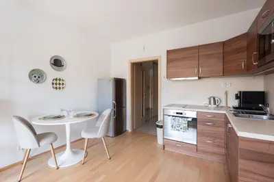 a kitchen with a table and a small table and chairs at Stylish and Comfortable Studio in Prague